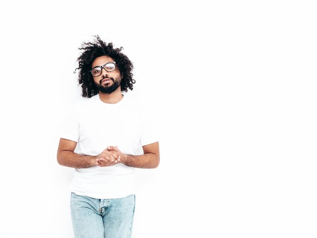 Handsome smiling hipster man posing in studio