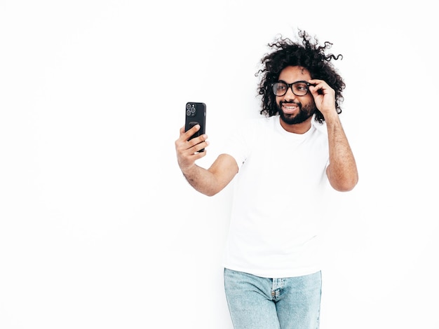 Handsome smiling hipster man posing in studio