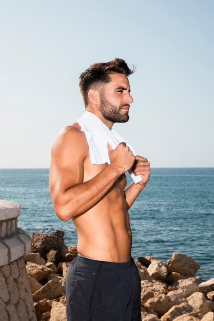 Free photo handsome sportive male having break after intense workout