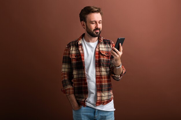 Handsome stylish hipster bearded man on brown