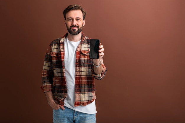 Handsome stylish hipster bearded man on brown