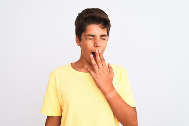 Handsome teenager boy standing over white isolated background bored yawning tired covering mouth with hand Restless and sleepiness