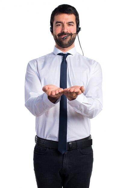 Handsome telemarketer man holding something