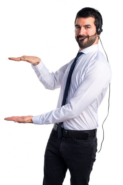 Handsome telemarketer man holding something