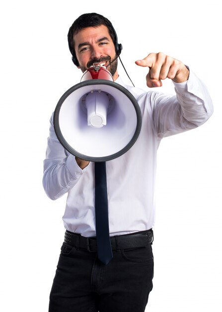 Handsome telemarketer man shouting by megaphone