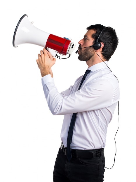 Handsome telemarketer man shouting by megaphone