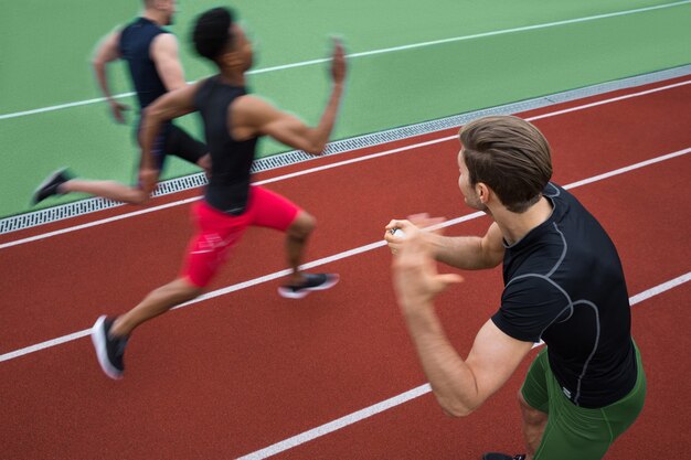 Handsome trainer screaming near young multiethnic athlete group