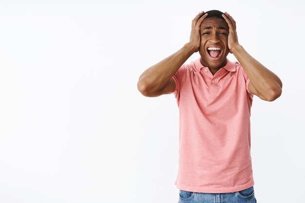 Handsome young African-American with pink polo Tshirt