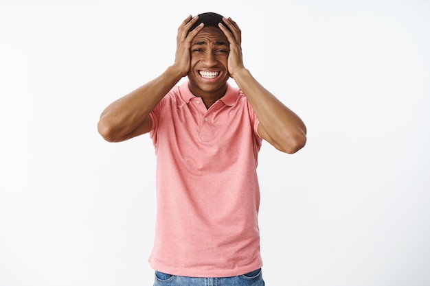 Handsome young African-American with pink polo Tshirt