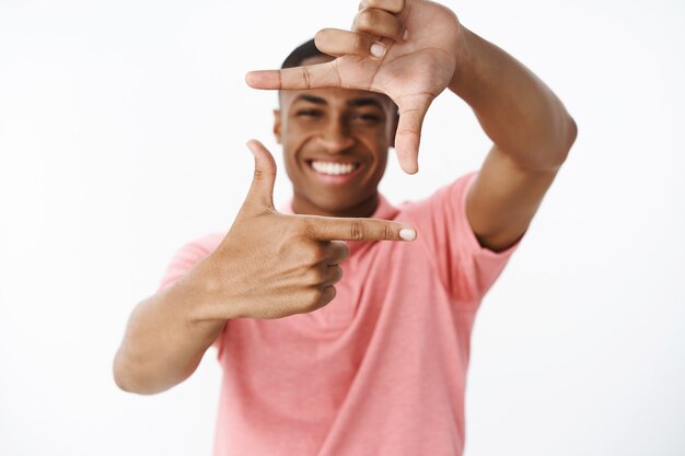 Handsome young African-American with pink polo Tshirt