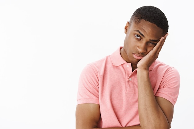 Free photo handsome young african-american with pink polo tshirt