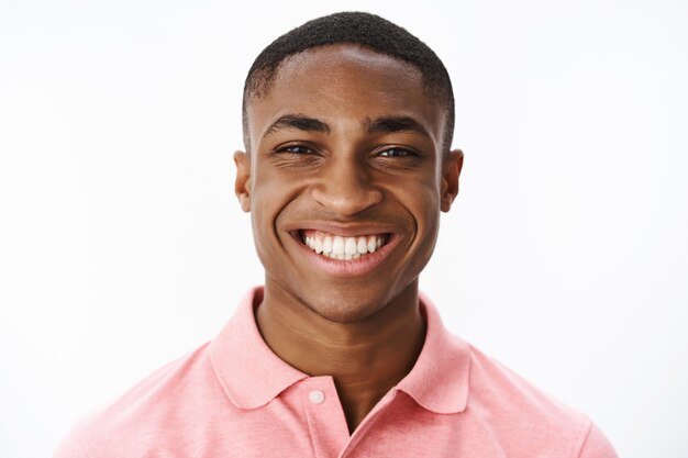 Handsome young African-American with pink polo Tshirt