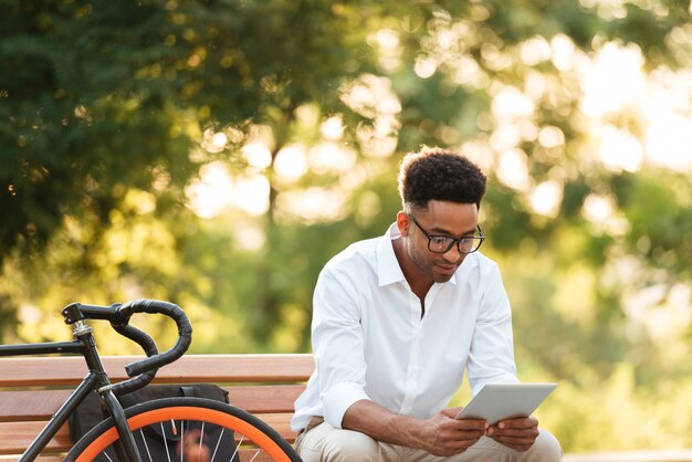 Handsome young african man using tablet computer.