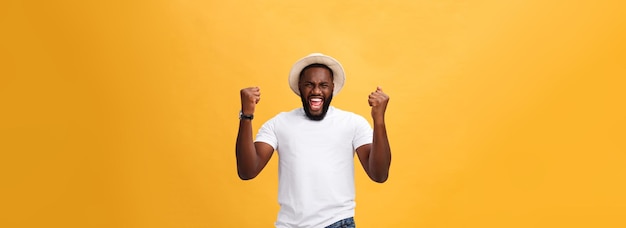 Handsome young afroamerican man employee feeling excited gesturing actively keeping fists clenched e