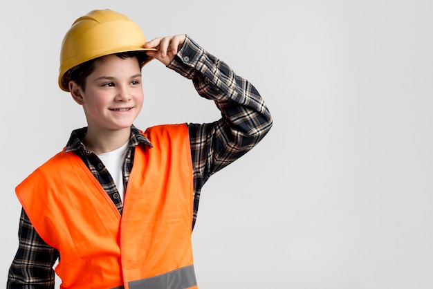 Handsome young boy posing with hard hat