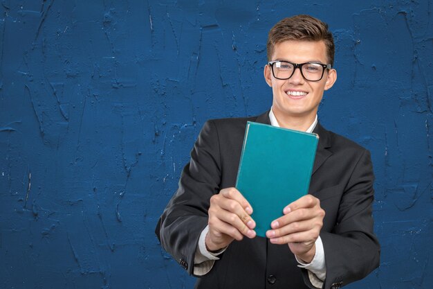 Handsome young business man with a book