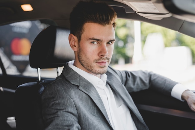 Handsome young businessman in the car