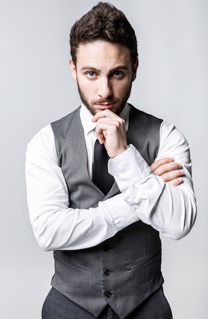 Handsome young businessman looking at camera. Isolated on white.