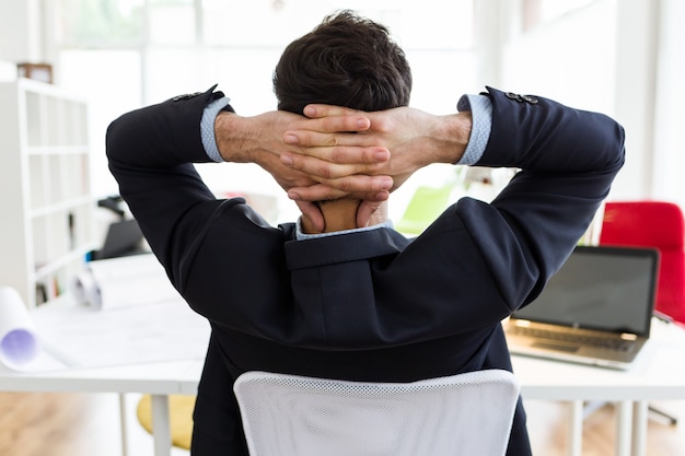 Free photo handsome young businessman relaxing one moment in the office.