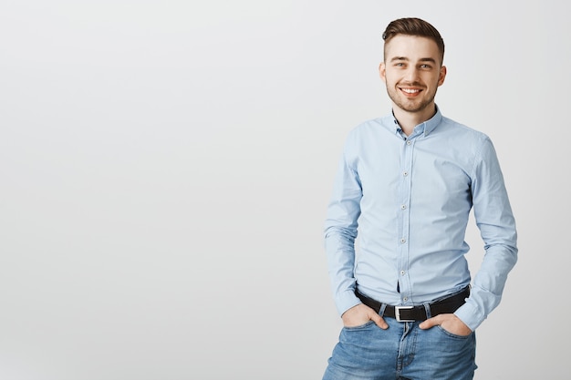 Handsome young businessman smiling confident