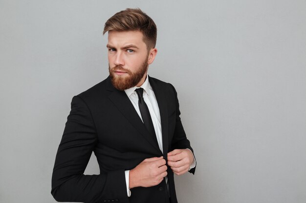 Handsome young businessman in suit standing