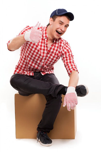 Handsome young courier with brown box