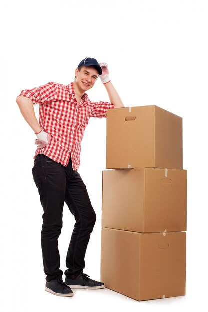 Handsome young courier with brown boxes