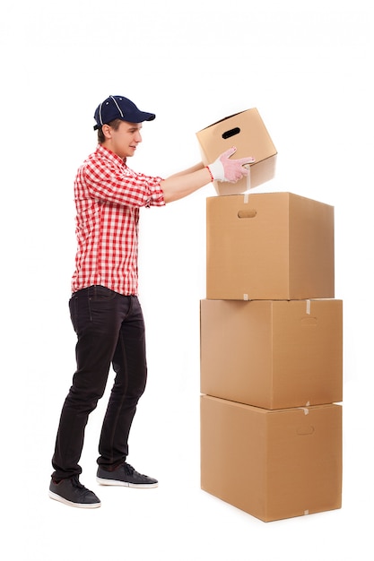 Handsome young courier with brown boxes