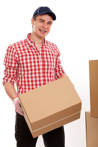 Handsome young courier with brown boxes