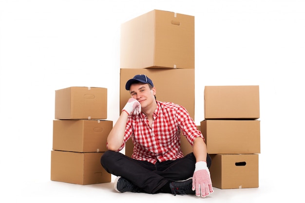 Handsome young courier with brown boxes