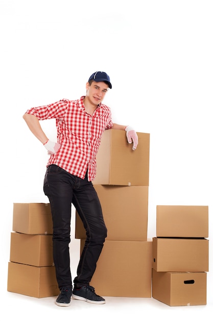 Handsome young courier with brown boxes