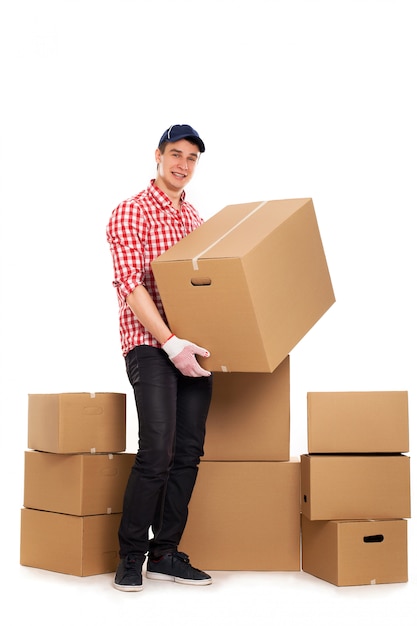 Handsome young courier with brown boxes