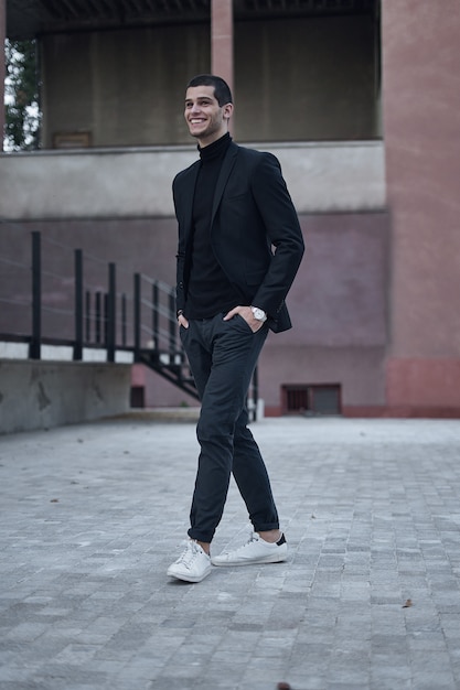 Handsome young male walking on the street