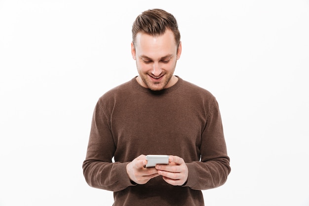 Handsome young man chatting by mobile phone