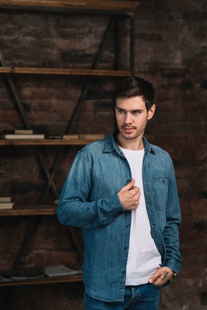 Free photo handsome young man in denim jacket looking away