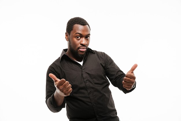 Handsome young man dressed in shirt with thumbs up