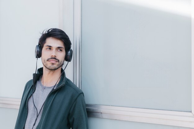 Handsome young man in earphones outside