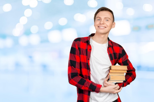 Free photo handsome young man holding books
