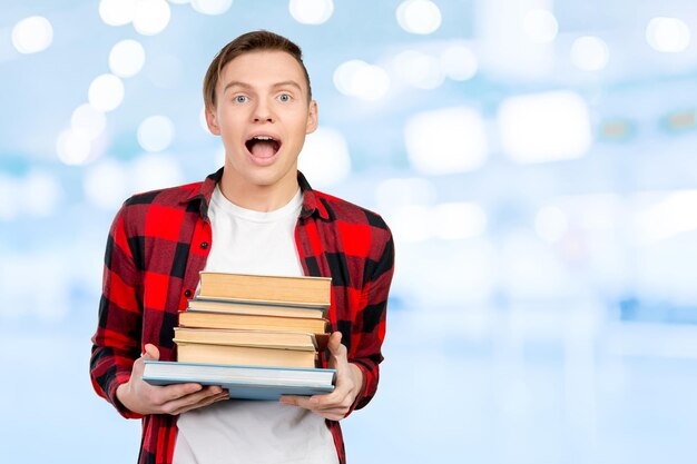 Free photo handsome young man holding books