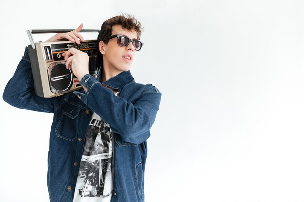 Handsome young man holding boombox