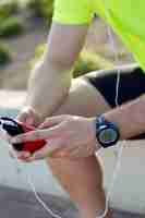 Free photo handsome young man listening to music after running.