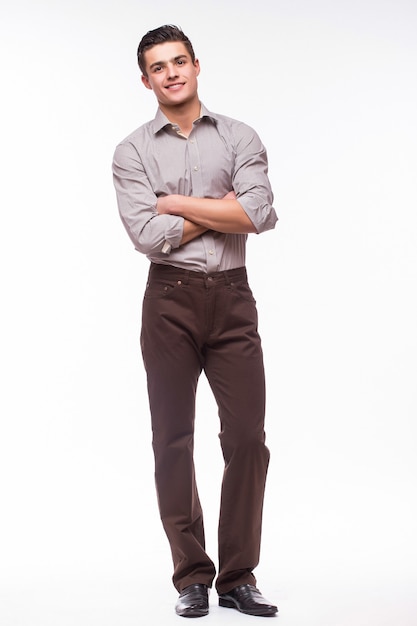 Handsome young man in shirt while standing against white wall