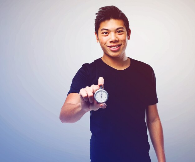 Handsome young man showing a chronometer