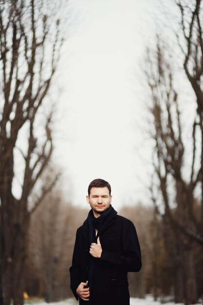 Handsome and young man strolling in the park alone