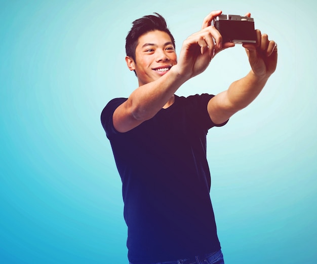 Handsome young man taking photo