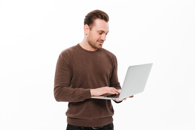 Handsome young man using laptop computer.