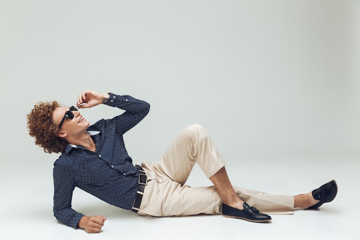 Free Photo handsome young retro man dressed in shirt lies on floor