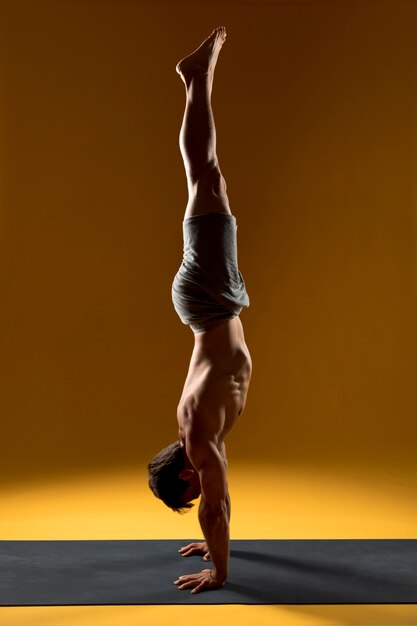 Handstand yoga pose on mat