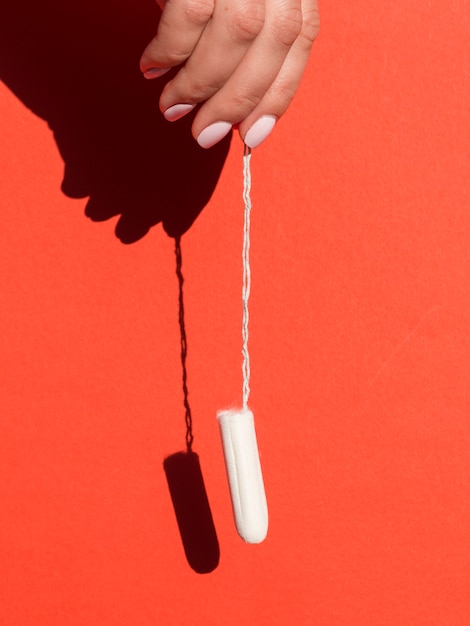 Free photo hanging tampon held by hand