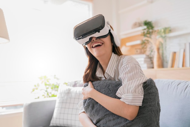 Happiness exited asian female teen hand wave along with her virtual concert performance via virtual goggle virtual interactive headsetasia woman stay home innovation technology lifestyle vr at home